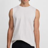 Front view of snow player top on model wearing black pants, against white background.