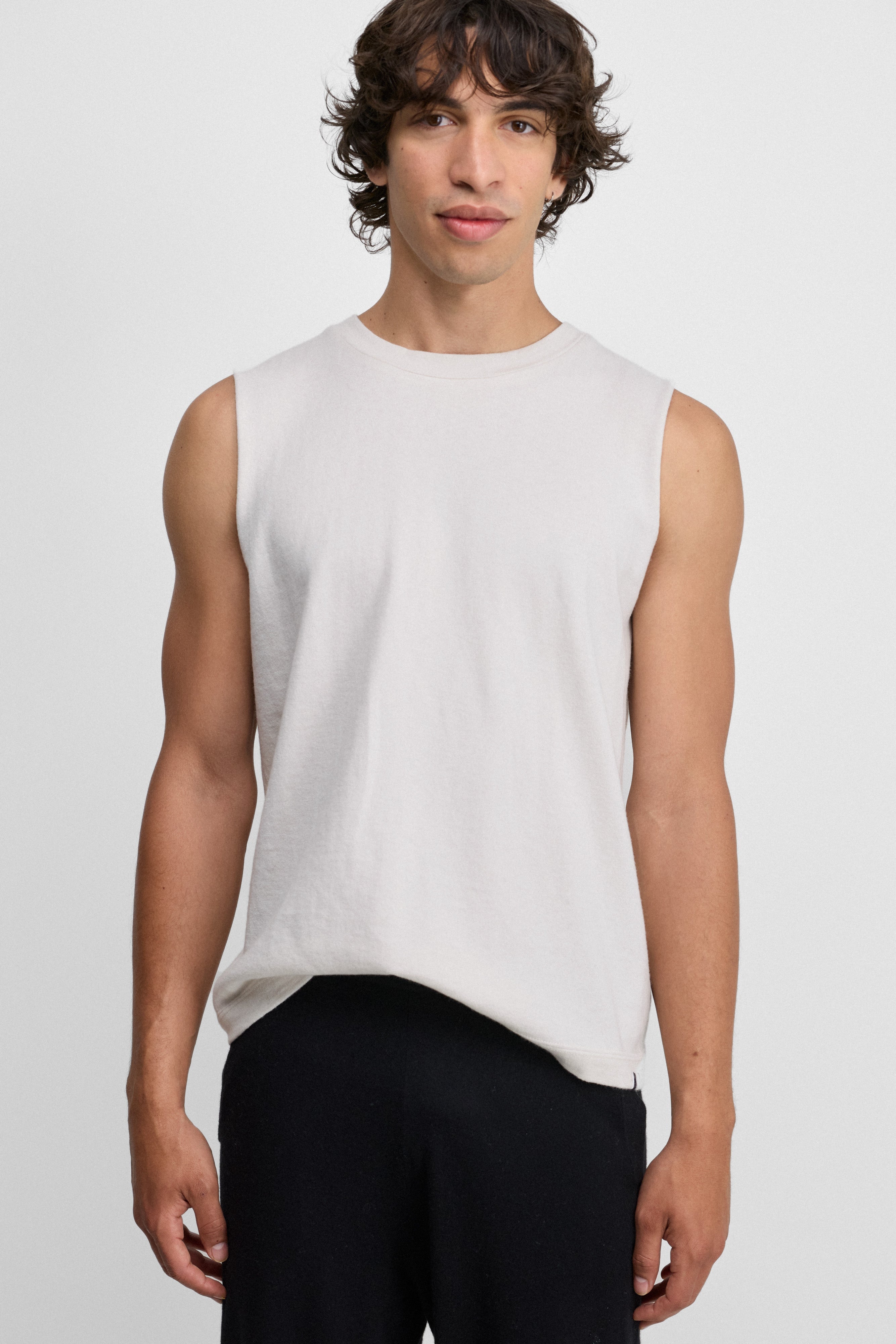 Front view of snow player top on model wearing black pants, against white background.