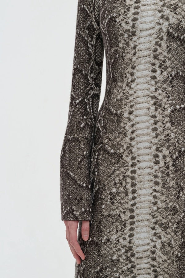 Side closeup view of greyscale aalia dress on model, against a white background.