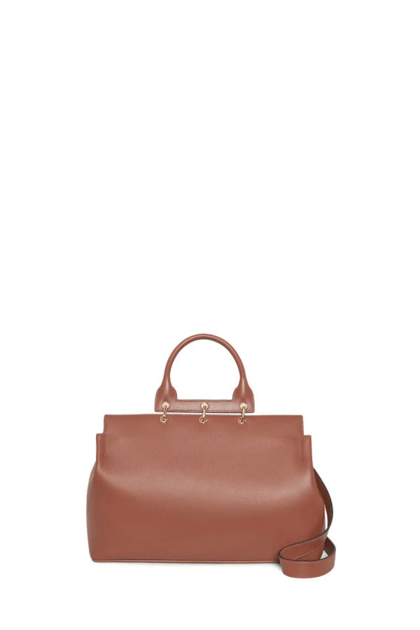 Front view of cognac amethyst tote showing strap on white background with no model showing
