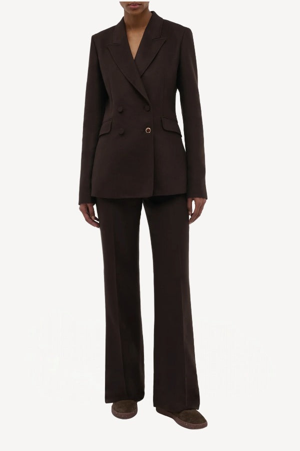Front view of chocolate vesta pant on model wearing chocolate stephanie blazer and sneakers, against a white background.