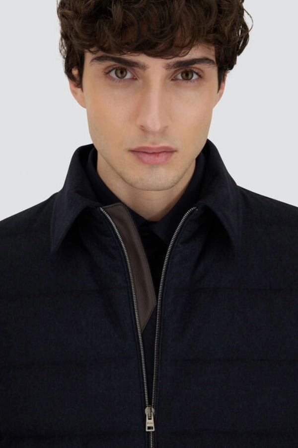 Front closeup view of blue men's jacket on model, against a white background.