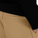 Back closeup view of cammello laminar trousers on model wearing black t-shirt, against a white background.