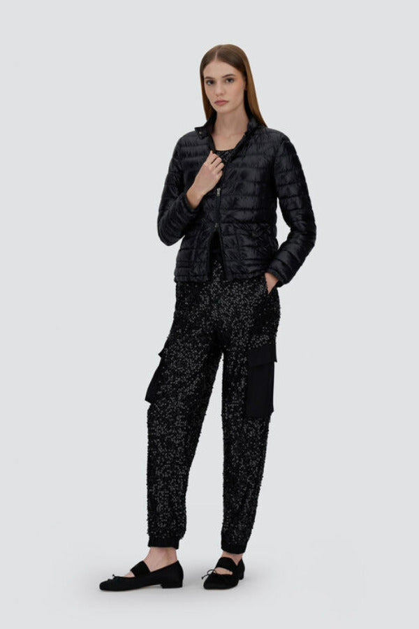 Front view of black bomber jacket on model wearing black t-shirt, trousers and mary janes against a white background.