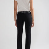 Back view of black tuxedo julep pants on model wearing white t-shirt and flats, against a white background.