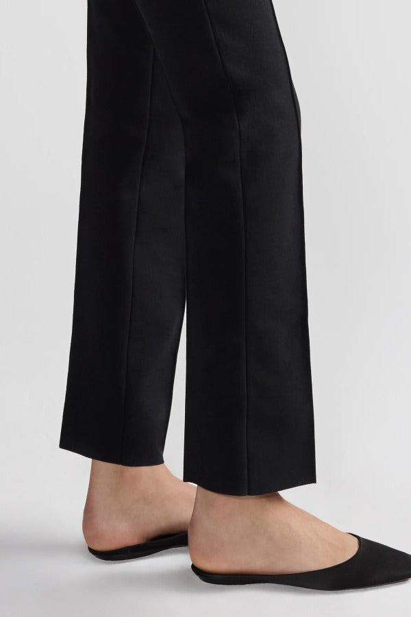 Bottom of pant closeup view of black tuxedo julep pant on model wearing flats, against a white background.