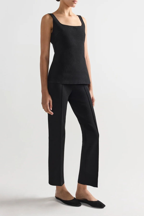 Alternate front slanted view of black combo windowpane inna top on model wearing black pants and flats, against a white background.