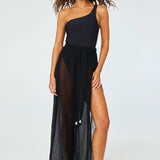 Front view of black wide leg pants open sides on brown-haired model wearing black swim suit, against a white background.