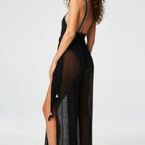 Side view of black wide leg pants on brown-haired model wearing black swimsuit, against a white background.