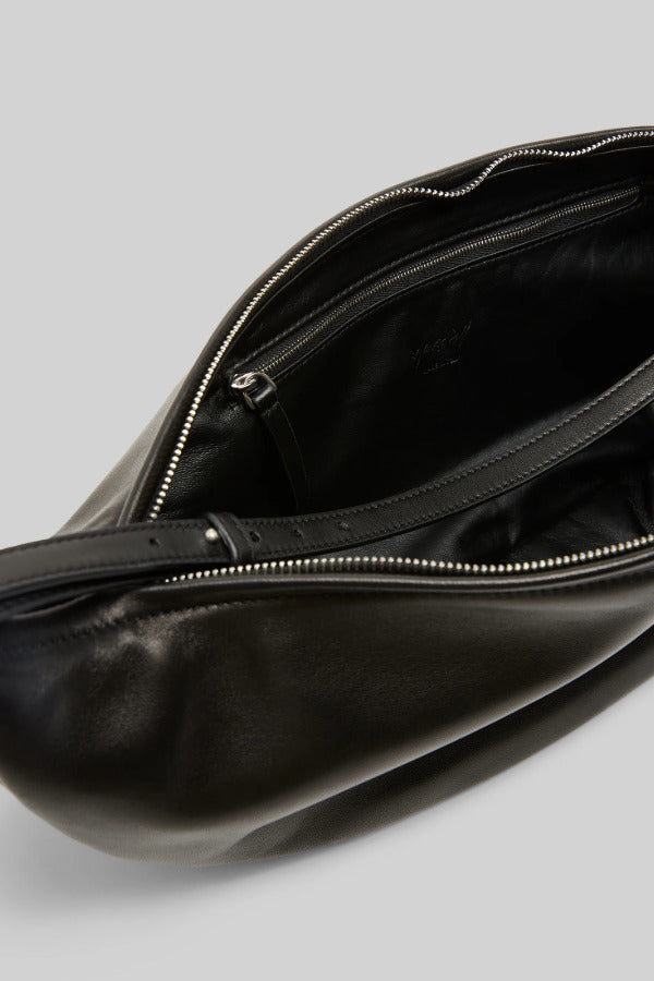Open view of black marsell volta shoulder bag on white background, with no model shown.