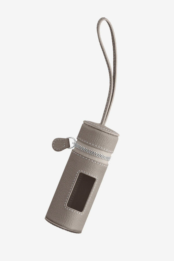 Front view of taupe the pouchette dog bag holder on white background, with no model shown.
