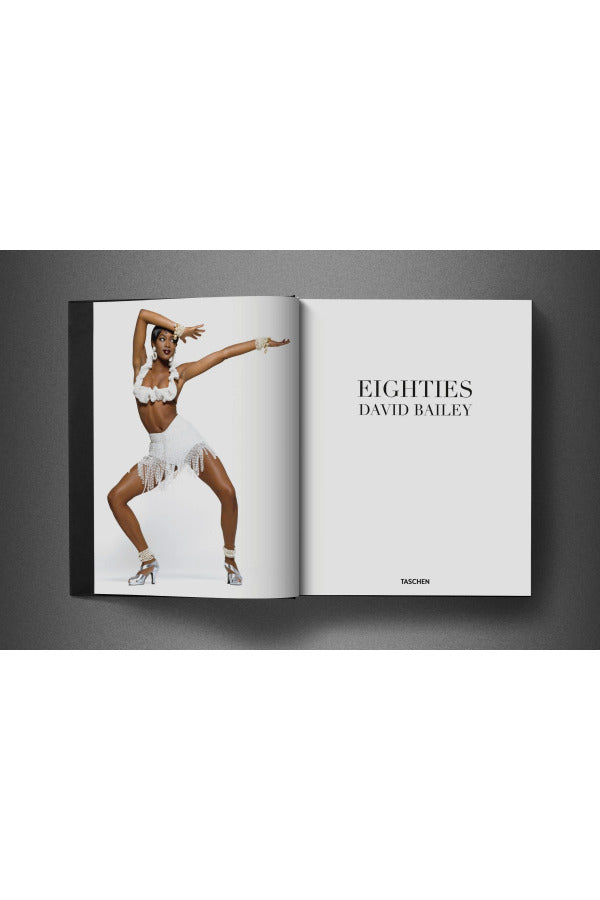 Open view of taschen david bailey eighties book on charcoal background.