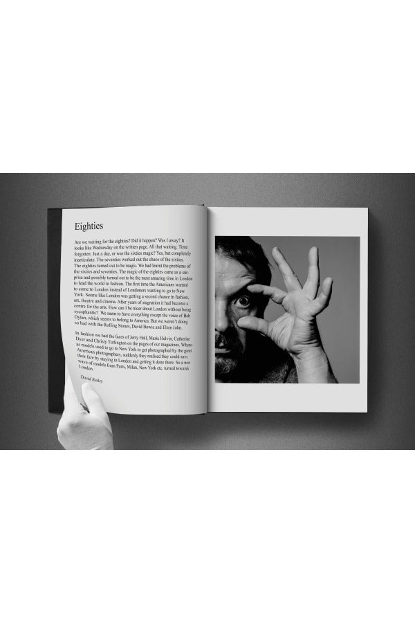 Open view of taschen david bailey eighties book on charcoal background.