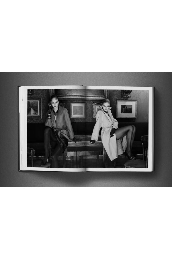 Open view of taschen david bailey eighties book on charcoal background.