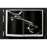 Open view of taschen helmut newton's Legacy book on black background.