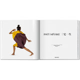 Open book view of taschen issey miyaki on white background.