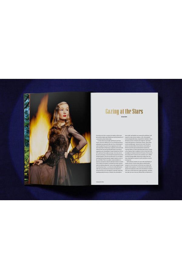 Open view of taschen life hollywood book on blue background.