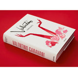 Side view of taschen Valentino book on red background.