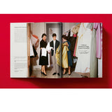 Open book view of taschen valentino book on red background.