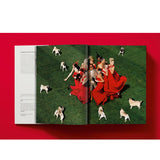 Open book view of taschen valentino book on red background.