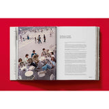 Open book view of taschen valentino book on red background.