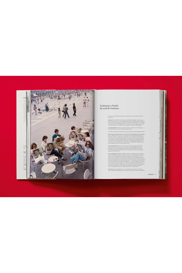 Open book view of taschen valentino book on red background.