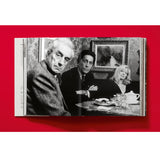 Open book view of taschen valentino book on red background.