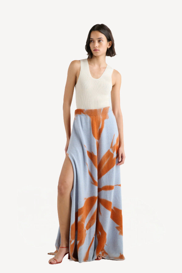 Front view of ice persimmon side slit skirt on model wearing white tank top and sandals, against a white background.