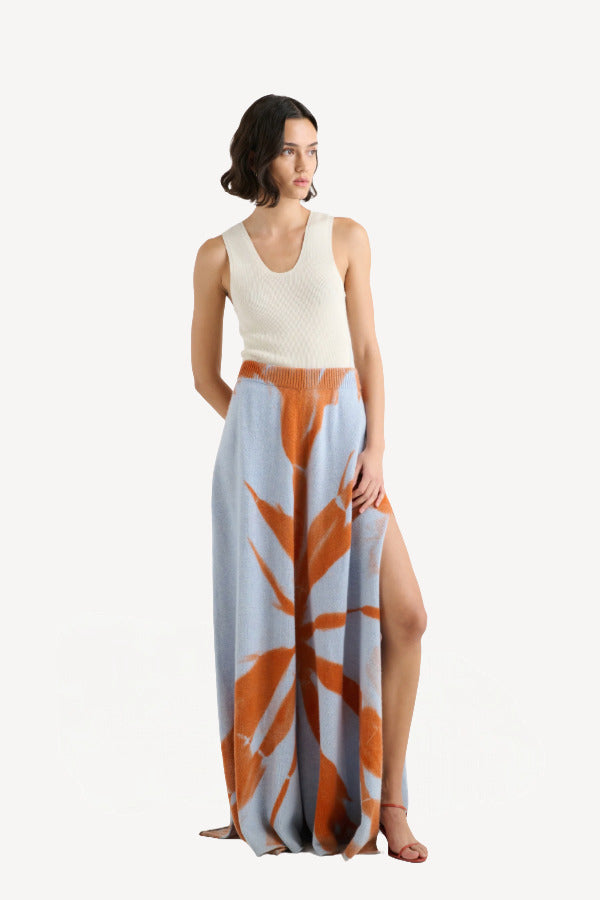 Front view of ice persimmon side slit skirt on model wearing white tank top and sandals, against a white background.
