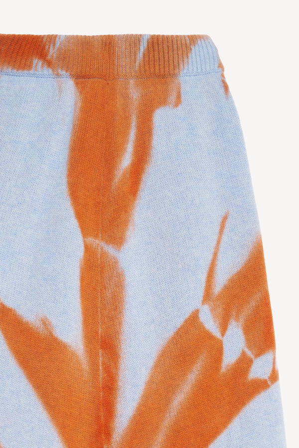 Front closeup view of ice persimmon side slit skirt on white background, with no model shown.