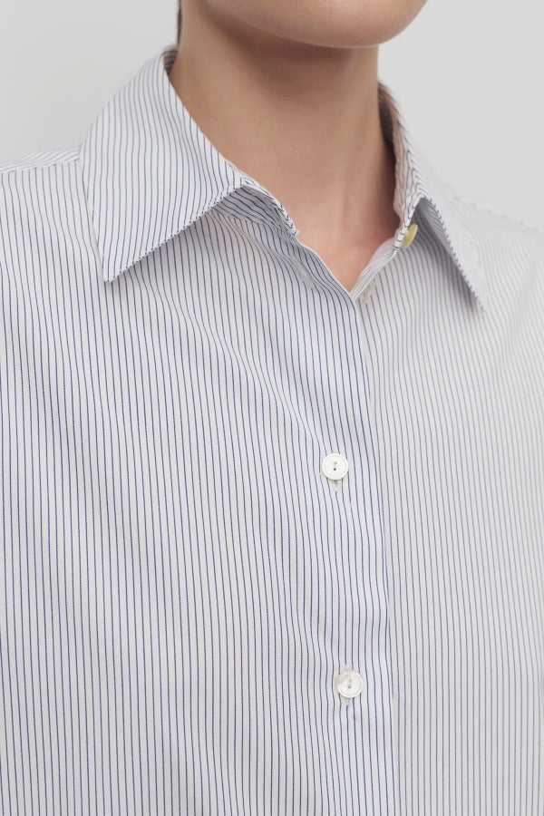 Front closeup view of blue/white cotton sisilia shirt on model, against a white background.