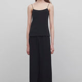 Front view of black gala pant on model wearing black top, against a white background.