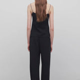 Back view of black gala pant on model wearing black top, against a white background.