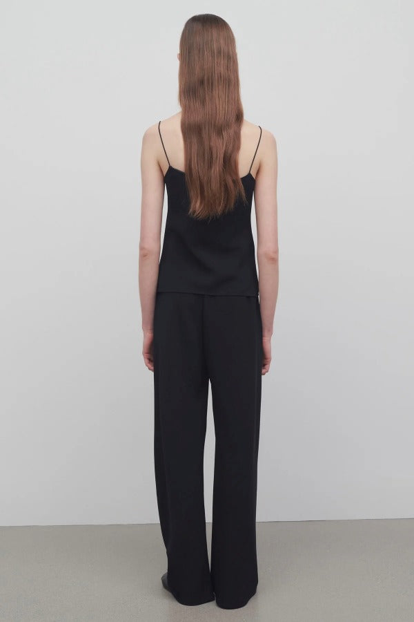 Back view of black gala pant on model wearing black top, against a white background.