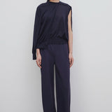 Front view of navy gala pant on model wearing black top and mules, against a white background.