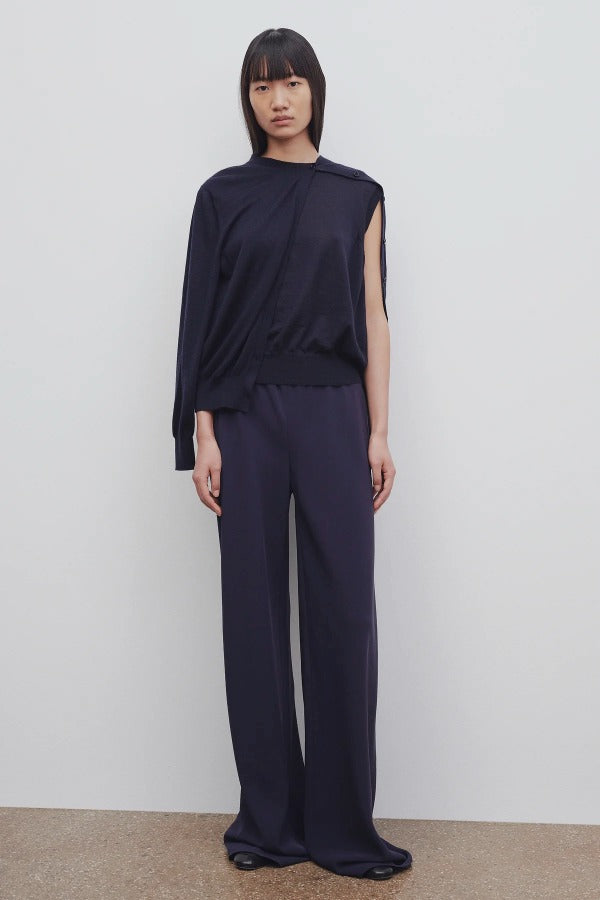 Front view of navy gala pant on model wearing black top and mules, against a white background.
