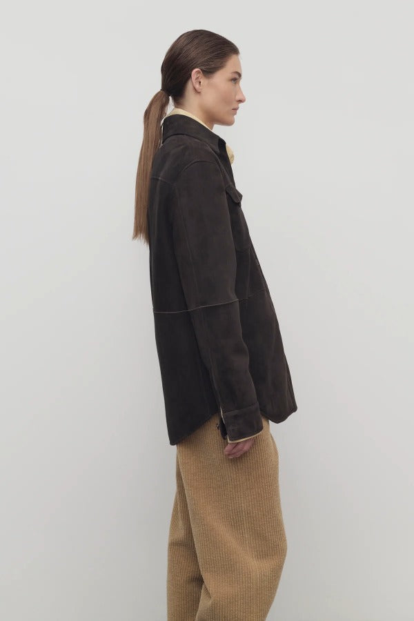 Side view of dark brown gwena jacket on model wearing khaki pants, against a white background.