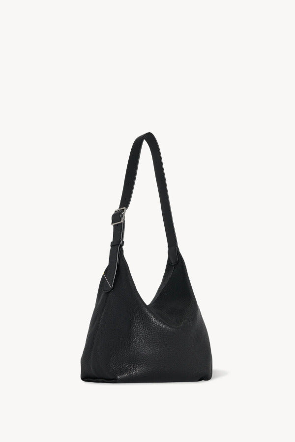 Back view of black isa shoulder bag on white background, with no model shown.