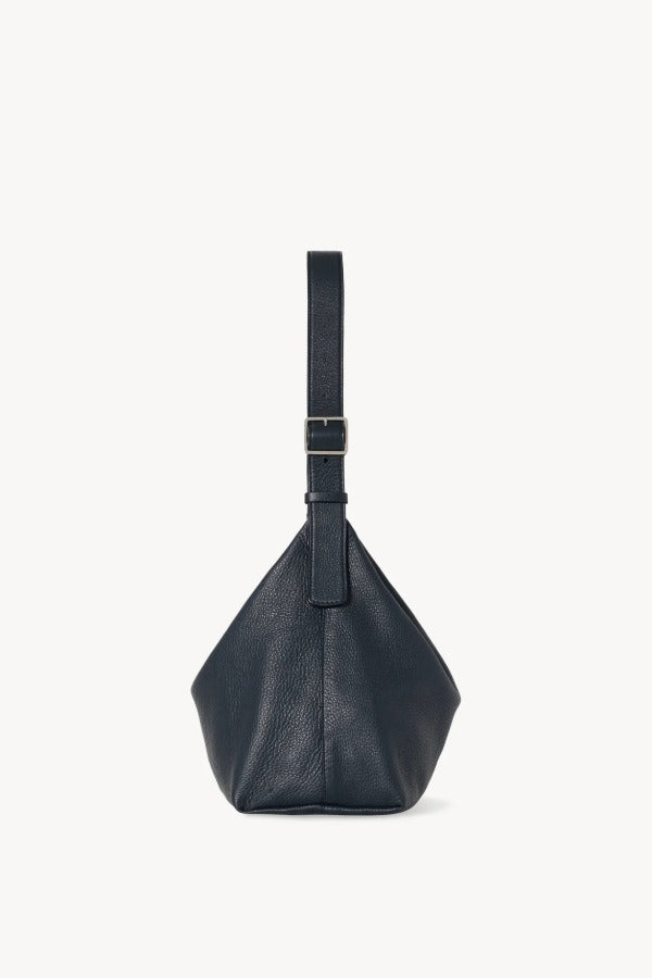 Side view of blu notte isa shoulder bag on white background, with no model shown.