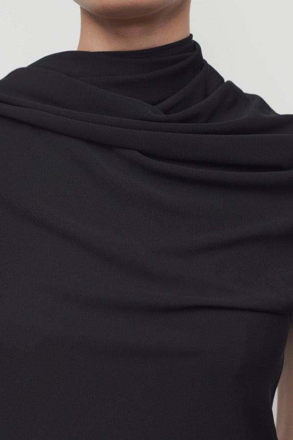 Front closeup view of black isadra top on model, against white background.
