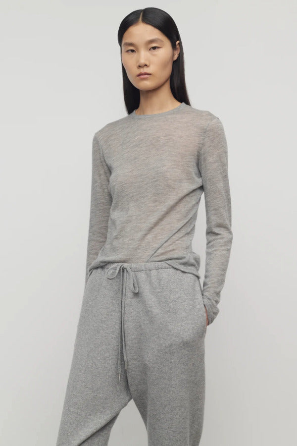 Front view of grey melange iverness top on model wearing grey sweatpants, against a white background.