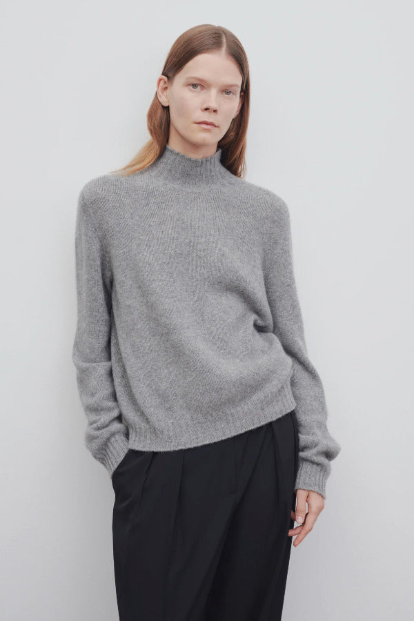 Front view of medium heather grey kensington top on model wearing black trousers, against a white background.