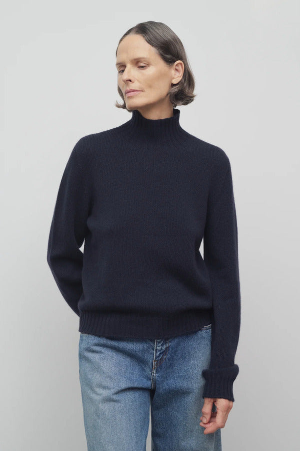Front view of dark navy kensington top on model wearing jeans, against a white background.