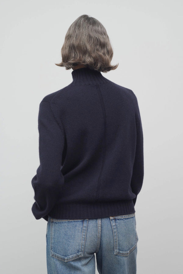 Back view of dark navy kensington top on model wearing jeans, against a white background.