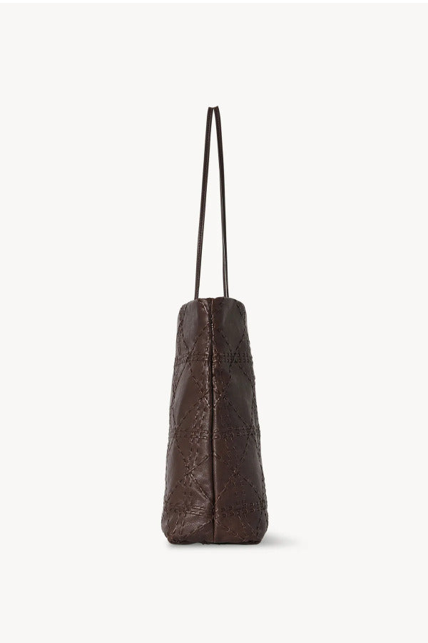 Side view of brown lilou woven tote on white background, with no model shown.