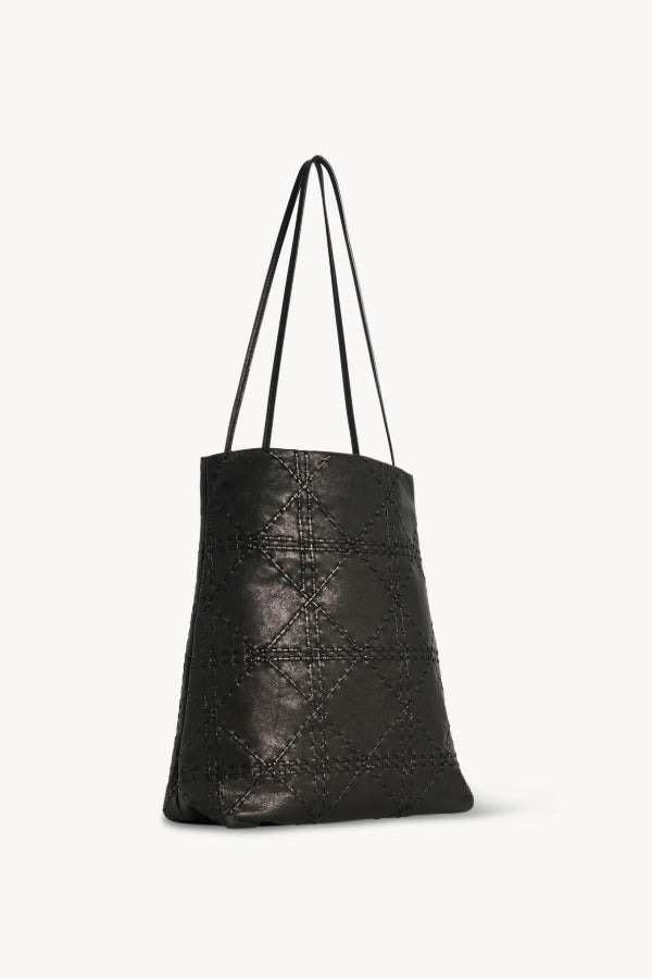 Back view of black lilou woven tote on white background, with no model shown.