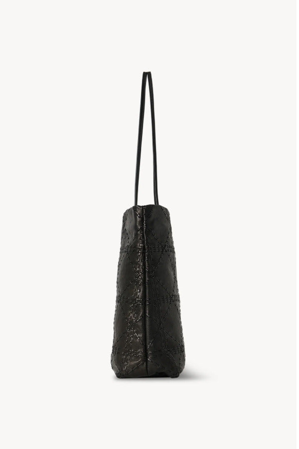 Side view of black lilou woven tote on white background, with no model shown.