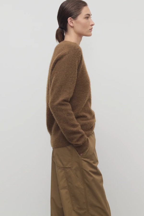 Side view of oak lorynna top on model wearing camel trousers, against a white background.