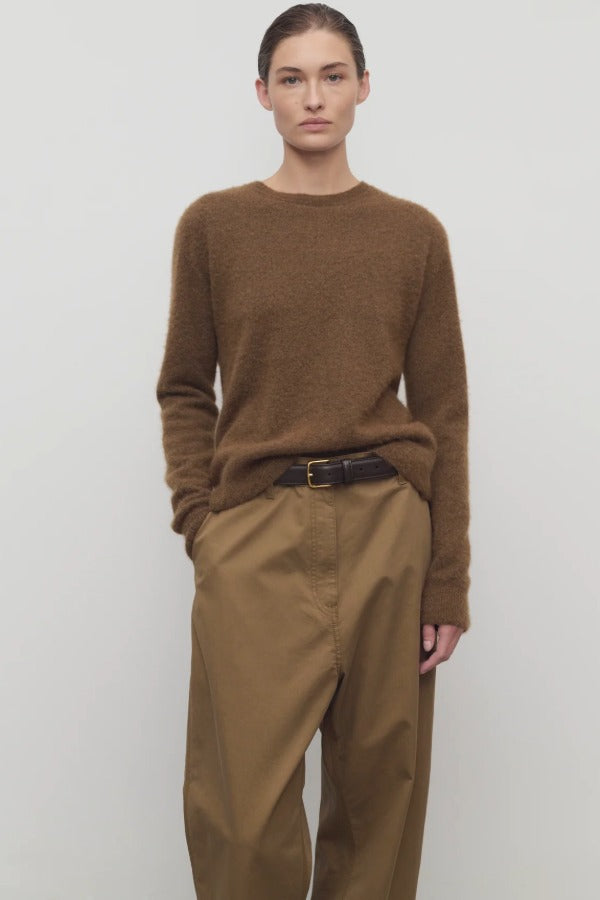 Front view of oak lorynna top on model wearing camel trousers and brown belt, against a white background.