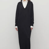 Front view of black luza dress on model wearing white collar shirt and black wedges, against a white background.